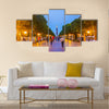 The evening walk along the illuminated Avenue with a view on the modern Clock Tower Multi panel canvas wall art