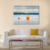 One seagull bird standing resting on an orange buoy multi panel canvas wall art