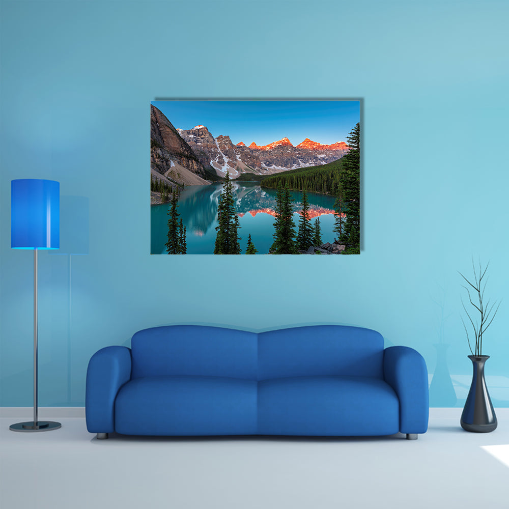 A beautiful sunrise at Moraine Lake with snow covered peaks multi panel canvas wall art