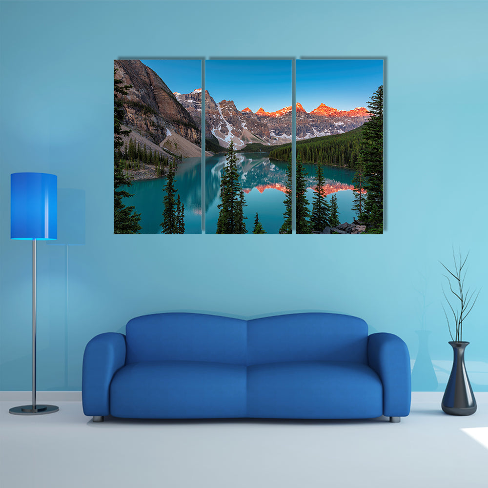 A beautiful sunrise at Moraine Lake with snow covered peaks multi panel canvas wall art