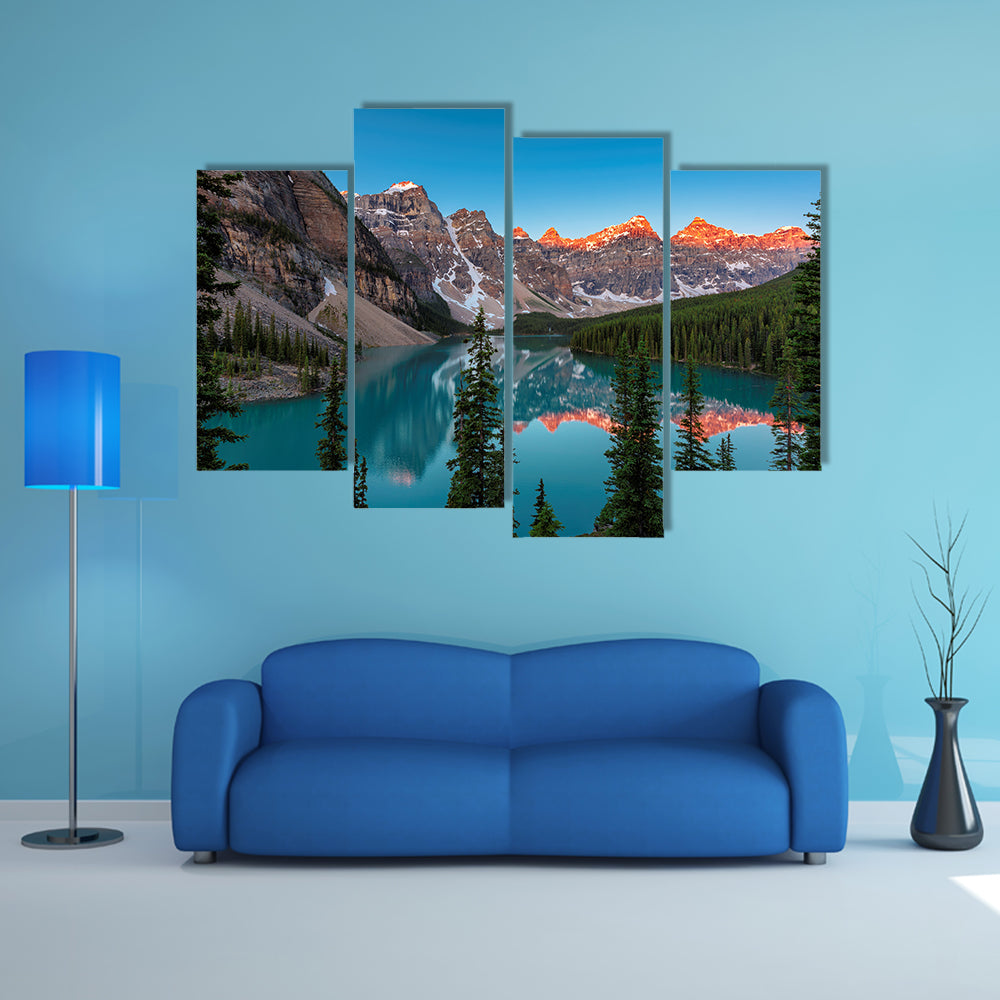 A beautiful sunrise at Moraine Lake with snow covered peaks multi panel canvas wall art