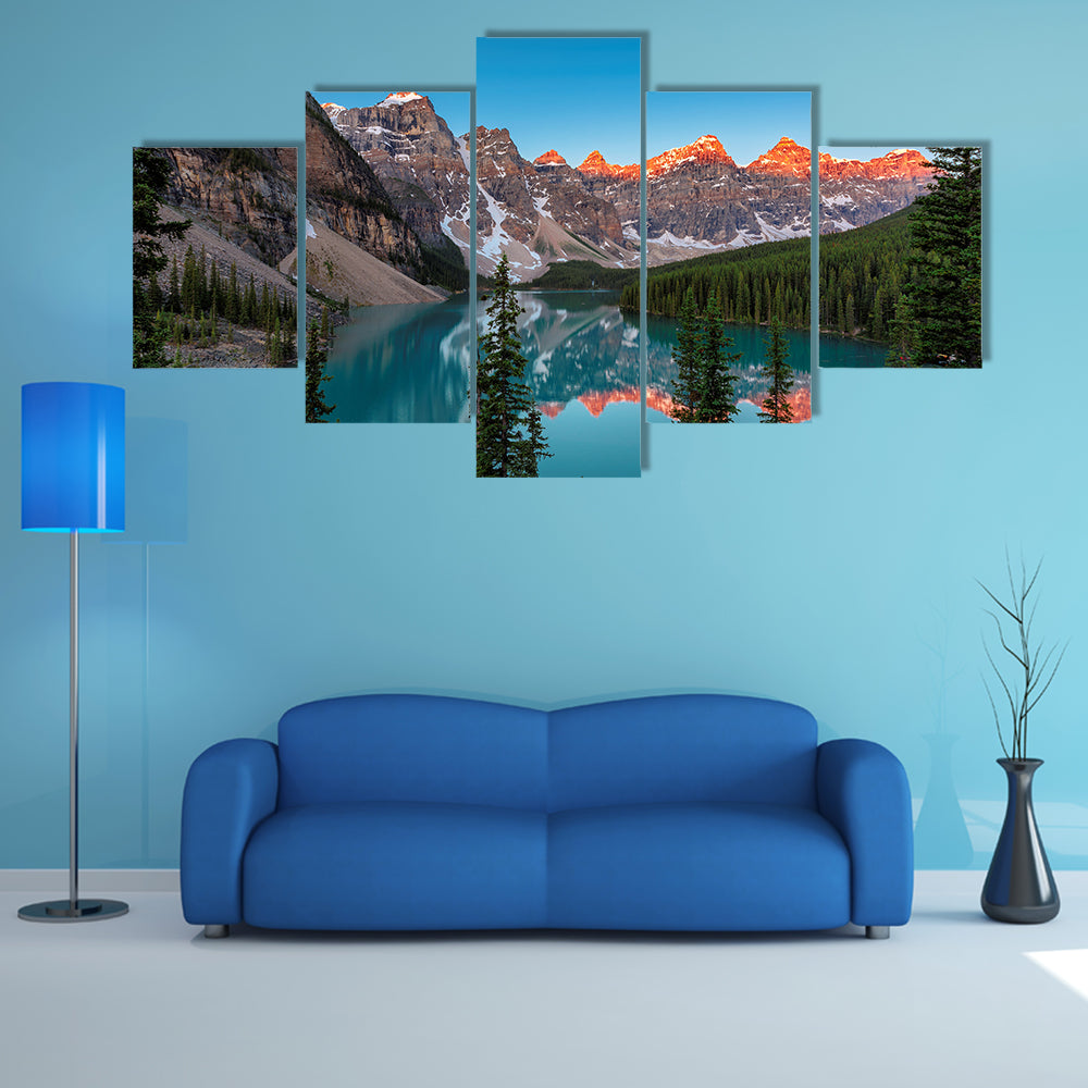 A beautiful sunrise at Moraine Lake with snow covered peaks multi panel canvas wall art