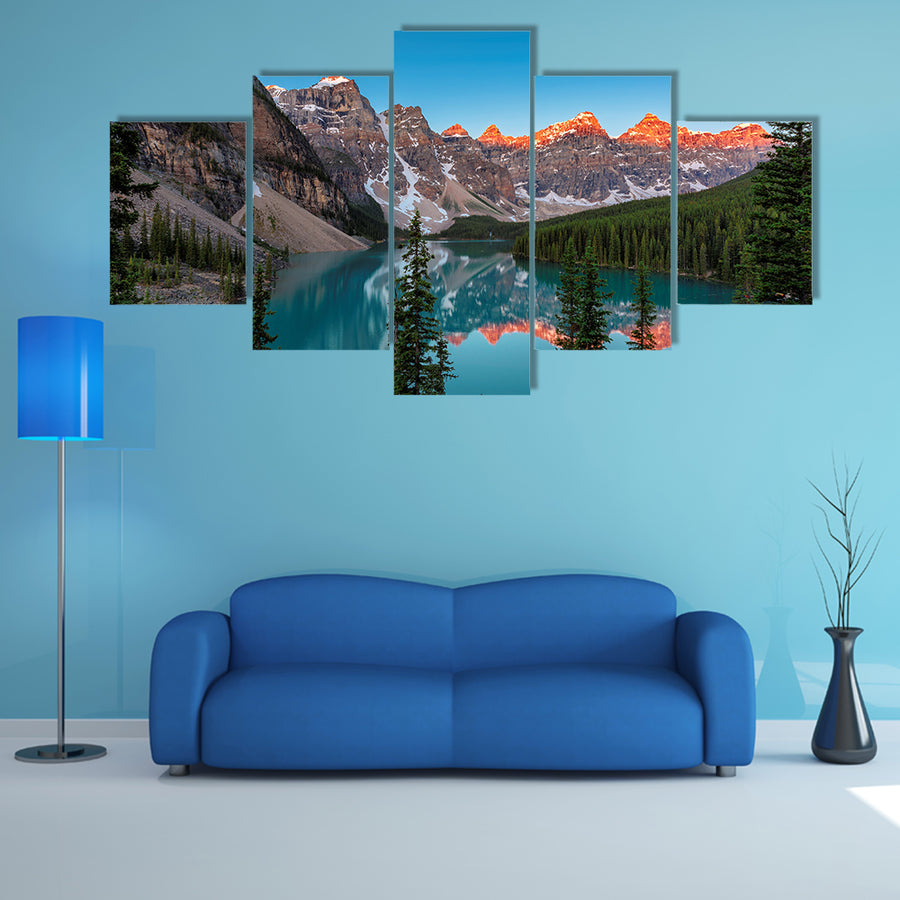 A beautiful sunrise at Moraine Lake with snow covered peaks multi panel canvas wall art