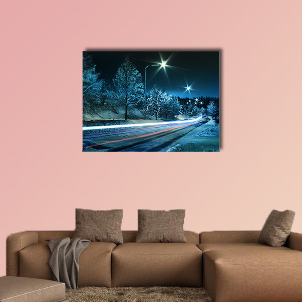 Small town street traffic on dark cold winter evening canvas wall art