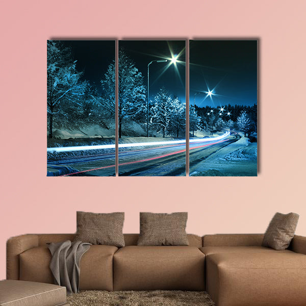 Small town street traffic on dark cold winter evening canvas wall art