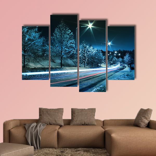 Small town street traffic on dark cold winter evening canvas wall art