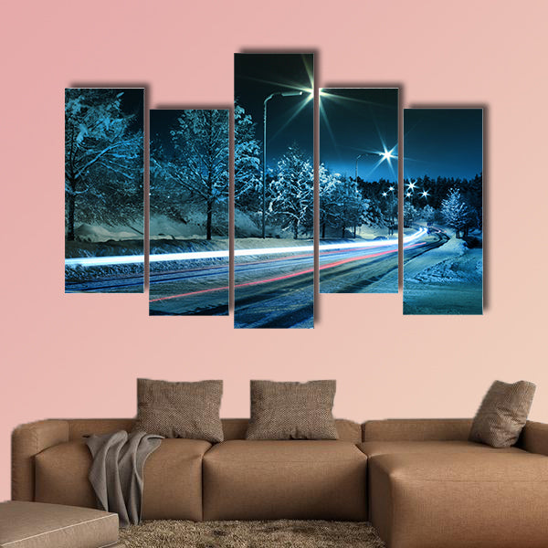 Small town street traffic on dark cold winter evening canvas wall art