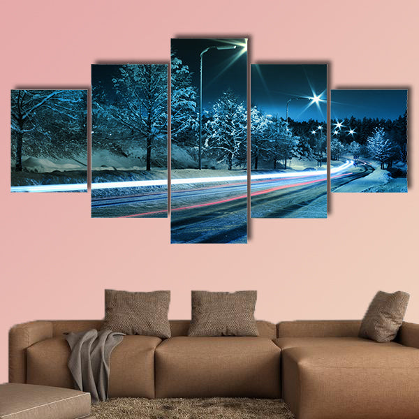 Small town street traffic on dark cold winter evening canvas wall art