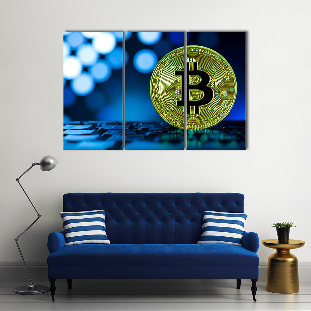 Golden bitcoin on keyboard against digital blue multi panel canvas wall art