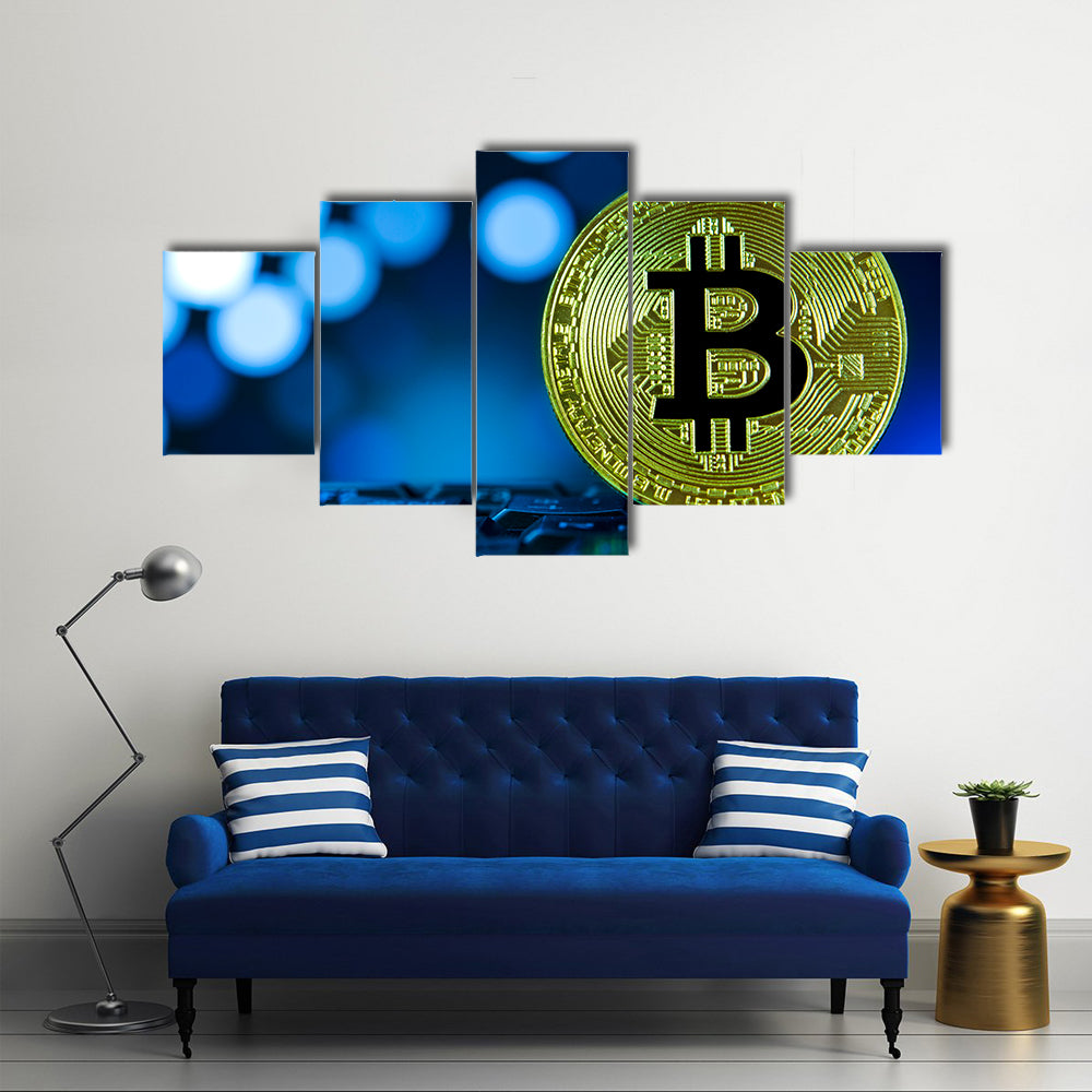 Golden bitcoin on keyboard against digital blue multi panel canvas wall art