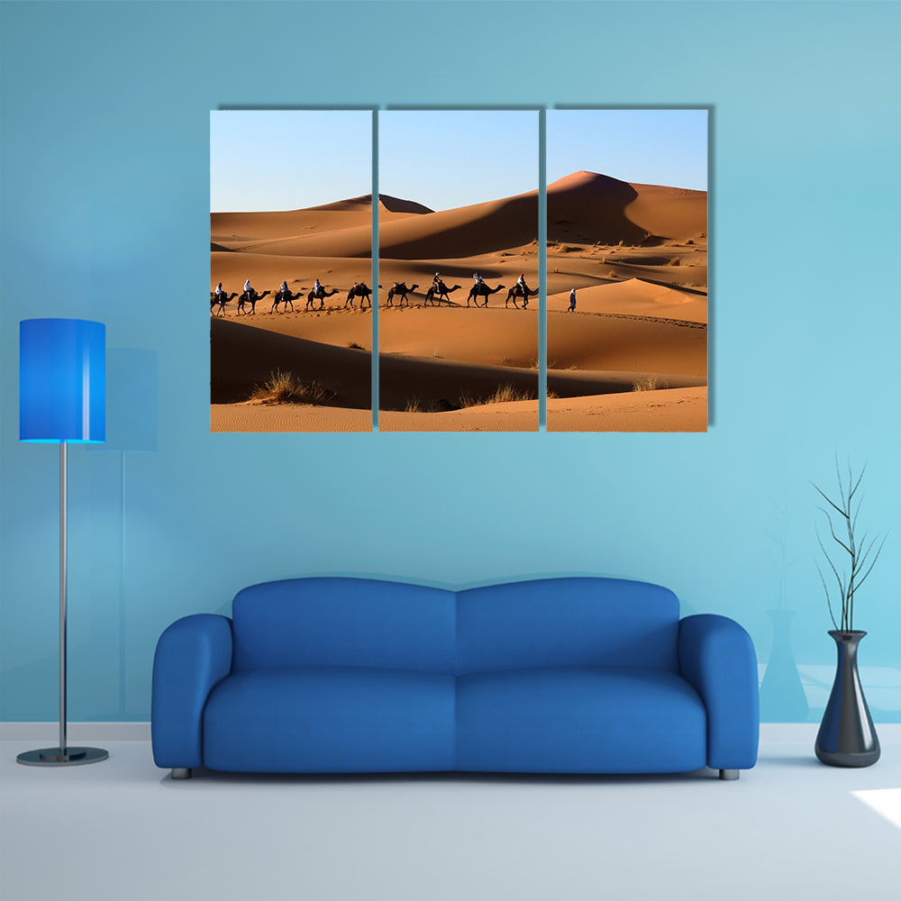 A Camel caravan going through the sand dunes in the Sahara Desert, Morocco multi panel canvas wall art