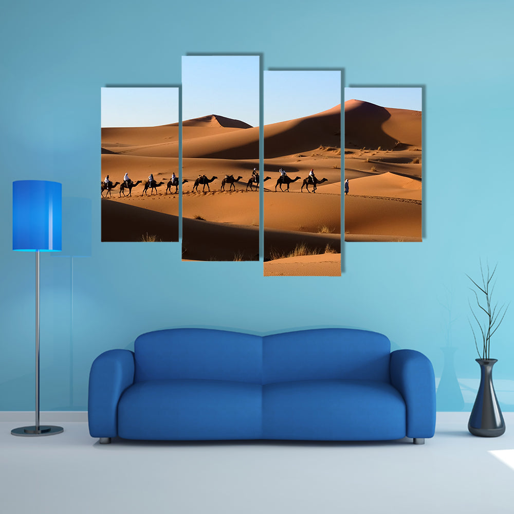 A Camel caravan going through the sand dunes in the Sahara Desert, Morocco multi panel canvas wall art