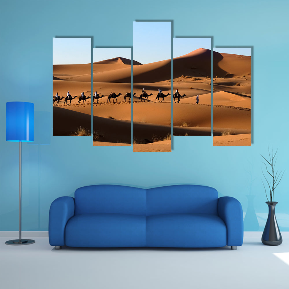 A Camel caravan going through the sand dunes in the Sahara Desert, Morocco multi panel canvas wall art