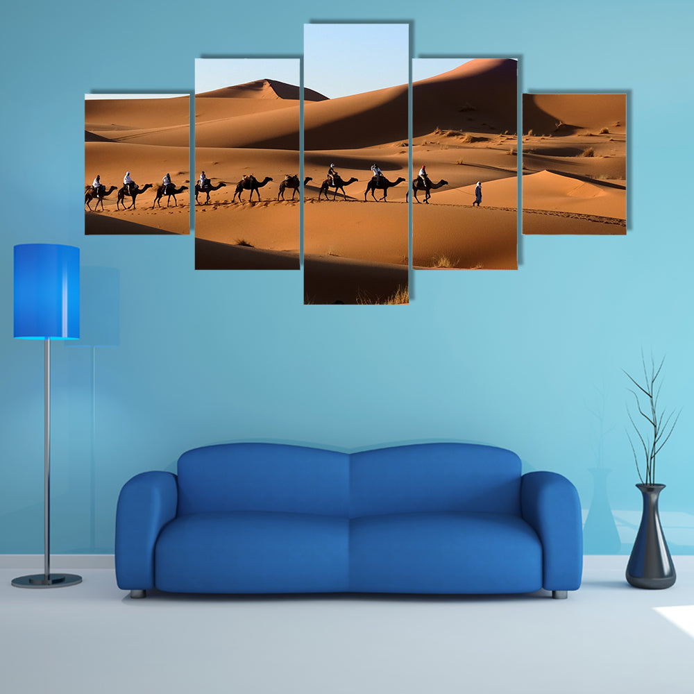 A Camel caravan going through the sand dunes in the Sahara Desert, Morocco multi panel canvas wall art