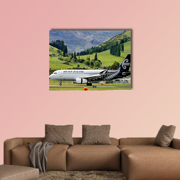 Airplane of Air New Zealand takes off from runway canvas wall art