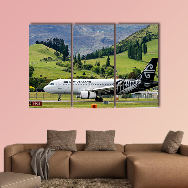 Airplane of Air New Zealand takes off from runway canvas wall art