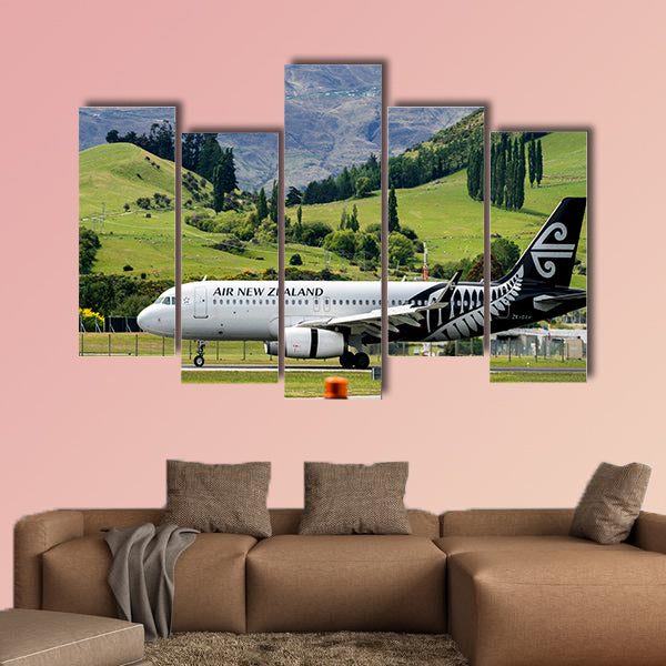 Airplane of Air New Zealand takes off from runway canvas wall art