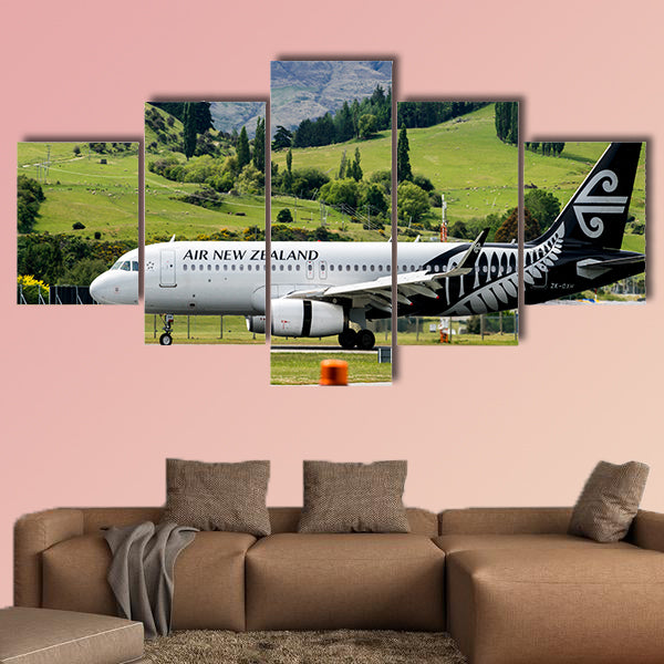 Airplane of Air New Zealand takes off from runway canvas wall art