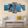 Three Dolphins are jumping and swimming in a pool multi panel canvas wall art