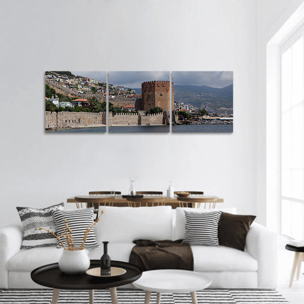 Seascape with Red tower and castle wall of Alanya shot Panoramic canvas Wall Art