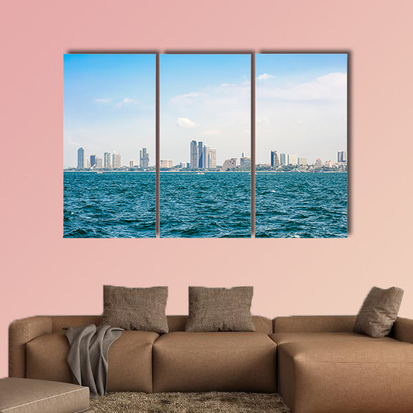 Speed boats and city buildings near the sea, sky and clouds  wall art
