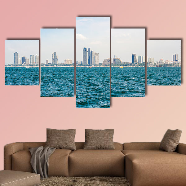 Speed boats and city buildings near the sea, sky and clouds  wall art