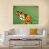 A beautiful Monarch Butterfly feeding on a Lantana bloom Multi Panel Canvas Wall Art