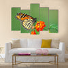 A beautiful Monarch Butterfly feeding on a Lantana bloom Multi Panel Canvas Wall Art