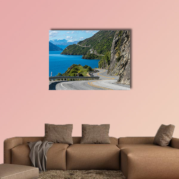 Winding road along mountain cliff and lake landscape in canvas wall art
