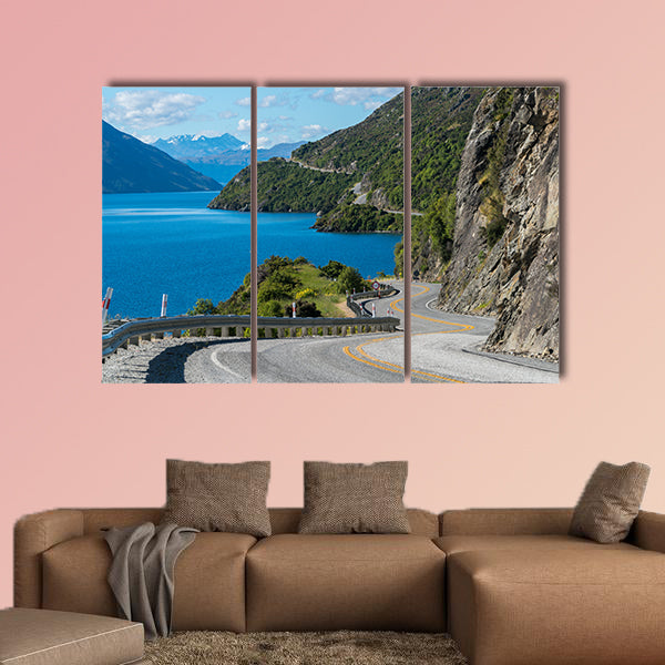 Winding road along mountain cliff and lake landscape in canvas wall art