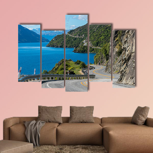 Winding road along mountain cliff and lake landscape in canvas wall art
