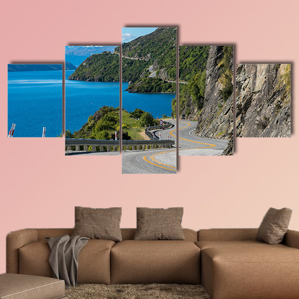 Winding road along mountain cliff and lake landscape in canvas wall art