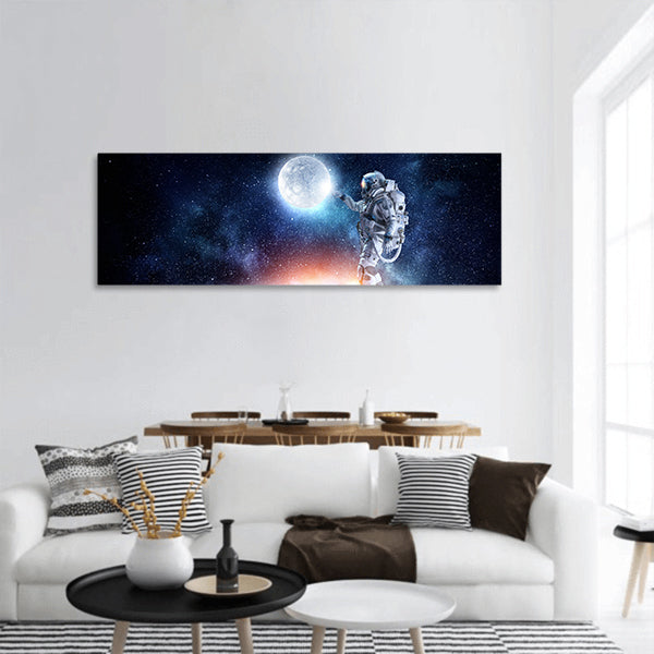 Astronaut pointing with finger on moon planet panoramic canvas wall art