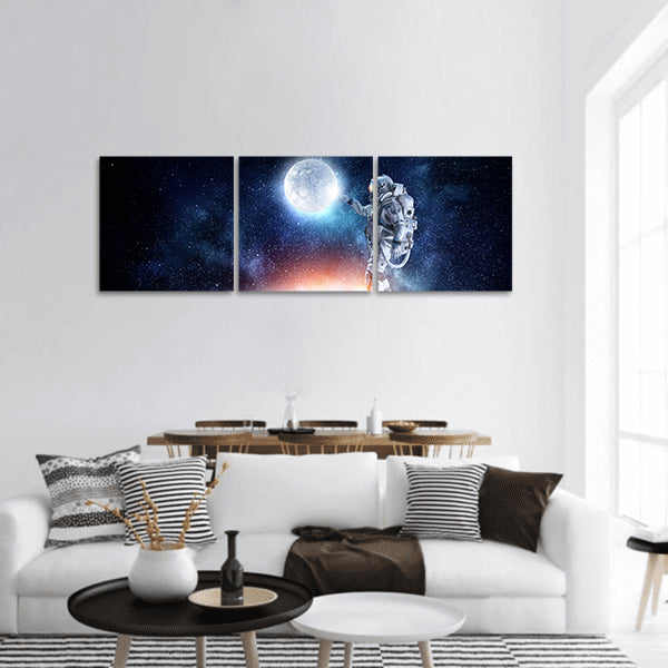 Astronaut pointing with finger on moon planet panoramic canvas wall art