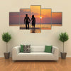 The image of two people in love at sunset multi panel canvas wall art