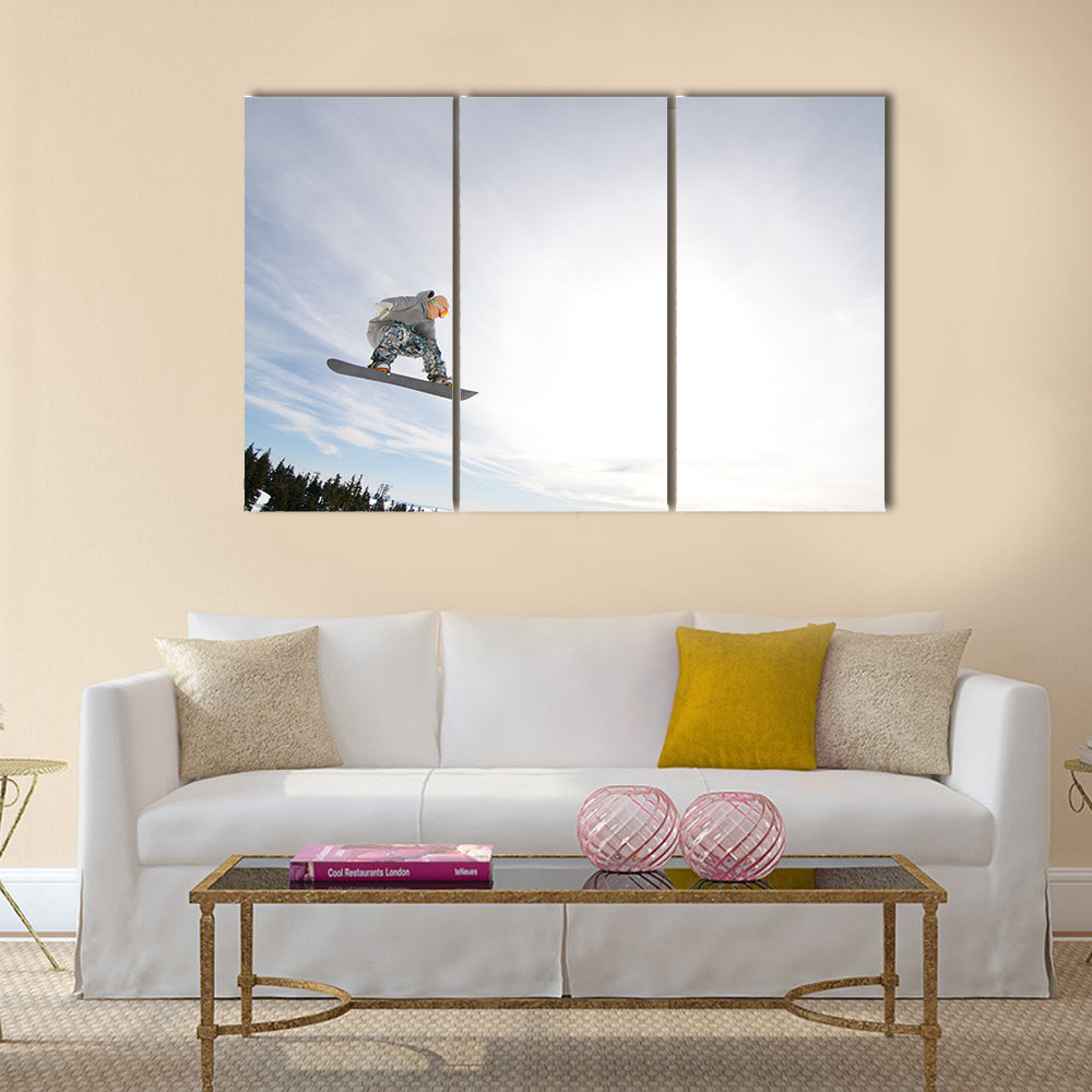 Men Snowboarder Catches Big Air on a Bright Sunny Day Multi panel canvas wall art