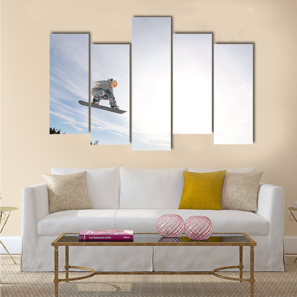 Men Snowboarder Catches Big Air on a Bright Sunny Day Multi panel canvas wall art