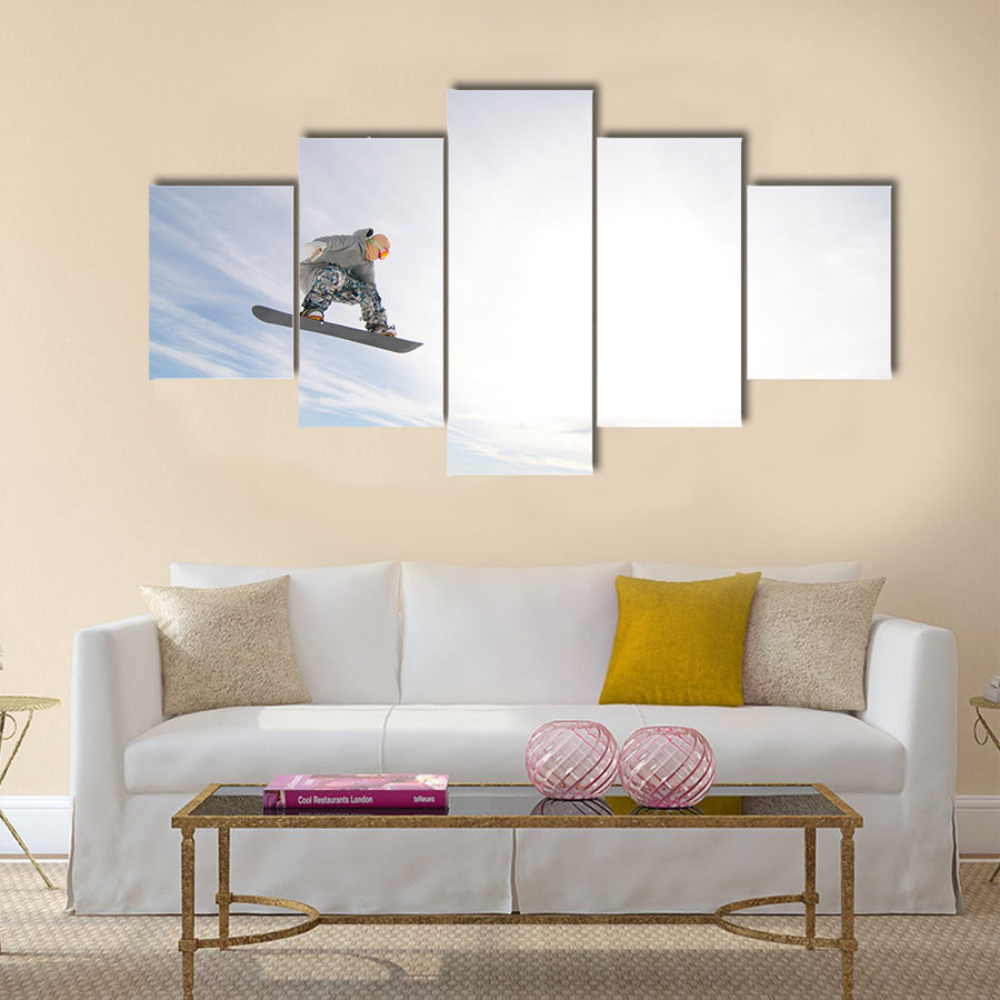 Men Snowboarder Catches Big Air on a Bright Sunny Day Multi panel canvas wall art
