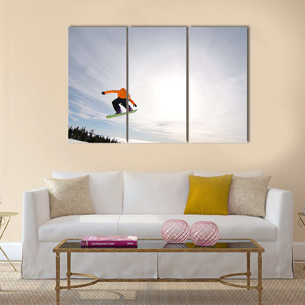 Male Snowboarder Catches Big Air on a Bright Sunny Day Multi panel canvas wall art