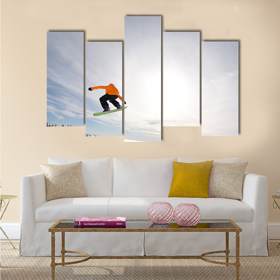 Male Snowboarder Catches Big Air on a Bright Sunny Day Multi panel canvas wall art
