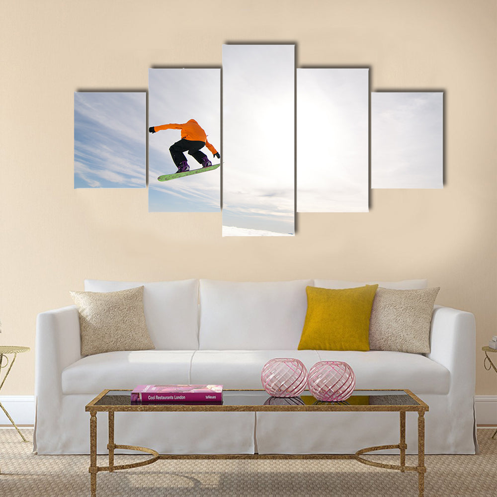 Male Snowboarder Catches Big Air on a Bright Sunny Day Multi panel canvas wall art