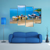 Unidentified tourists sailing in a boat on a Caribean beach in Taganga Colombia Multi Panel Canvas Wall Art