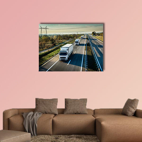 Caravan of white trucks in line on country highway wall art