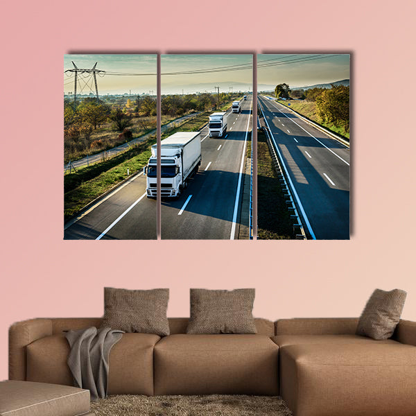 Caravan of white trucks in line on country highway wall art