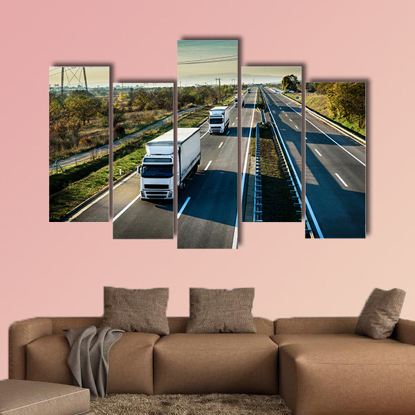 Caravan of white trucks in line on country highway wall art