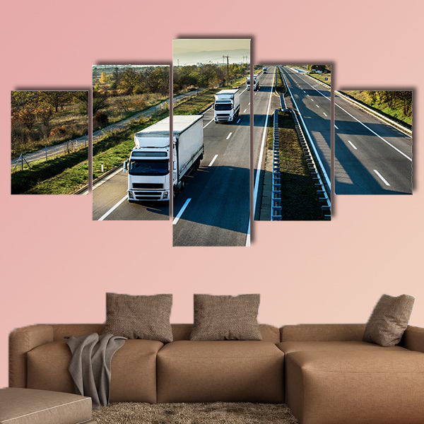 Caravan of white trucks in line on country highway wall art