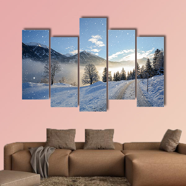 View of an icy road with snowfall and mountain range wall art