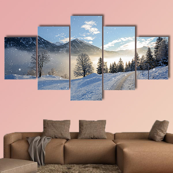 View of an icy road with snowfall and mountain range wall art