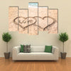 Word LOVE and hearts drawn on sand near water multi panel canvas wall art