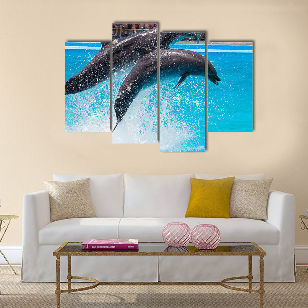 Two dolphins jump out of the pool water during the performance multi panel canvas wall art